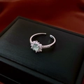 Detail of silver-tone open ring featuring green stone and white zircon cluster - Silver Floral Green Gemstone Style