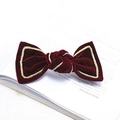Elegant deep red velvet bow hair clip with gold braided trim on open book pages - Wine Red Velvet Clip with Gold Trim