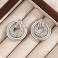 Elegant silver double-ring stud earrings with shimmering rhinestones on linen jewelry box - Double Hoop Rhinestone Pave Style (N-830) / 56 White K