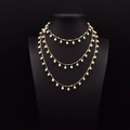 Three-layer gold necklace with natural white seed pearls on a black mannequin - Multi-Layer Artificial Pearl Necklace
