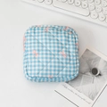 Detail view of a quilted blue gingham toiletry bag with pink bow prints and zipper - Plaid Blue Bow