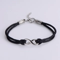 Detail of adjustable black braided rope bracelet with silver infinity symbol and clasp - Silver (Black Rope)
