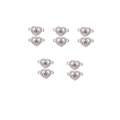 Macro detail of 10 heart-shaped Evil Eye alloy charms with blue zircons and silver finish - Silver Hollow Heart Blue Evil Eye (XH40717) / 10 Pieces Pack