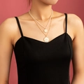 Close-up of layered gold chain necklace featuring white pearls and vintage coin pendants - Gold Double Pendant (NZ1270)