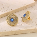Detail of gold titanium stud earring featuring blue gemstone and radiant crystal sunflower design - Gold Blue