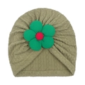 Detail of baby turban hat featuring green knit texture and 3D flower with red center - Green