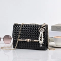 Black woven shoulder bag with a pearl bow charm and elegant metal chain strap - With Pendant / Small / Black