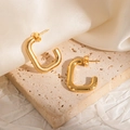 Elegant gold plated U-shaped rectangular hoop earrings on textured stone and silk background - Rectangular Open Stud Earrings
