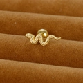 Macro shot of gold snake cartilage earring with textured finish and screw ball back - Snake / Gold / 0.1