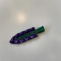 Macro view of wave-textured purple hair clip with green duckbill clamp on white background - Purple / Green Clip