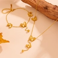 Detailed view of golden butterfly necklace and bracelet set with etched textures - Gold Color Butterfly Set