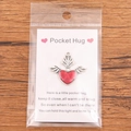 Pocket Hug heart pendant with silver wings on a greeting card in plastic packaging - Heart with Small Silver Wings