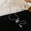 Detailed macro shot of silver rocking horse pendant and dollar sign charm on snake chain - Rocking Horse with Dollar Bag Pendant (3#) / Silver