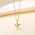 Close-up of gold star and Z-shape pendant with clear diamonds on a wavy chain - Gold