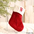 Red knit Christmas stocking with white cuff featuring a red letter W embroidery - Letter W