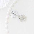 Macro shot of white enamel bow pendant with heart detail and textured silver metal back - 6# Bowknot-White