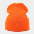 Detail of orange ribbed knit beanie featuring silver sun embroidery for outdoor warmth - Orange Red