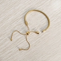 Detailed view of gold snake chain bracelet with adjustable slider and screw end closure - Bracelet Without Beads / Gold