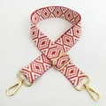 Detail of adjustable red and white geometric jacquard bag strap with gold metal hardware - Silver Clasp / Red