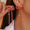 Sparkling red rhinestone bow earrings with long tassels in a high-fashion elegant style - Stud Earrings / Gold Red