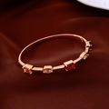 Macro shot of 18K rose gold plated bangle with colorful rectangle and oval gemstones - Real Gold Plated / Gold