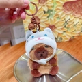 Cute capybara plush keychain with white cat hat and brown metal bell accessory - Cat Headwear 2.0