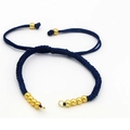 Detail of adjustable dark blue braided bracelet with golden beads on white background - Sapphire Blue
