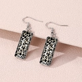 Detail shot of leopard print rectangular drop earrings on a textured pink surface - Classic Leopard Style (FXEH-27-7)