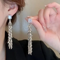 Elegant long silver tassel earrings with a square crystal stud on a model - Square Gem Leaf Tassel / Silver