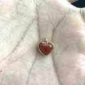 Golden titanium steel heart pendant with red stone charm shown in palm of hand - Red Agate Heart Pendant Only (Without Chain) / Gold
