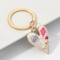 Golden heart keychain with evil eye and daisy patterns on a white marble texture - Style B / 3x7cm