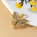 Macro shot of 3D gold butterfly pendant with colorful zircon stones on matte surface - W-Iridescent Butterfly Pendant