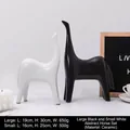 Abstract horse-shaped ceramic figurines set in black and white minimalist art style - Big Black And Little White Abstract Horse Combination