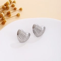 Detail of silver heart-shaped earrings with wave texture on a minimalist tray - Silver Ripple Heart (E7110)