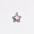 Detailed macro of silver star pendant with pink floral inlay and sparkling crystals - Pink