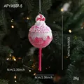 Pink and white lollipop Christmas ornament with glitter and beads on a festive tree - Lollipop Style