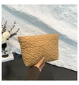 Detail of khaki quilted floral fabric pouch with soft padded texture and elegant finish - Khaki
