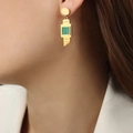 Elegant geometric gold titanium steel earrings with green striped inlay on a model - Pointed Turquoise Look (F1096)