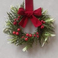 Mini Christmas wreath with lush green leaves, red berries and a large red velvet bow - Snowy Cypress Leaf Red Bow Wreath