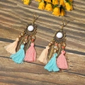 Detail of bohemian tassel earrings with bronze feathers and colorful beads on wood - Light Mix Gem Tassel