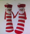 Hand-holding Christmas socks featuring Santa Claus design with red and white stripes - Red White Striped Santa Hand Holding