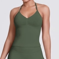 Close-up of seamless dark green halter yoga top showing V-neck and ribbed fabric texture - Olive Green