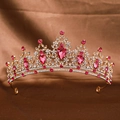 Detailed view of a golden bridal crown with sparkling rhinestones and pink gems on fabric - Gold Rose Pink