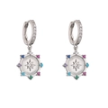 Macro detail of silver huggie earrings with colorful stones and starburst pendant - Silver Color Stone Badge