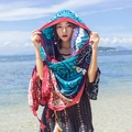Ethnic pattern sun protection shawl with tassels worn by a model on a sunny beach - Heart Floral Art