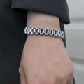 Silver stainless steel watchband style bracelet for women worn on a model's wrist - 18cm / Silver