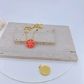 Detail of gold plated cherry blossom pendant with red enamel evil eye and sparkling stones - Bright Red Round Evil Eye