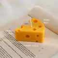 Cheese shaped handmade scented candle variant in bright yellow on vintage book - Small Cheese
