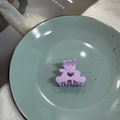 Purple matte bear hair claw clip with heart cutout on a blue ceramic plate - Purple