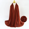 Red-brown pearl chiffon scarf for women with elegant drape on a mannequin - Red Brown